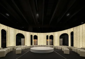 A minimalist conference space with modern materials and a circular platform