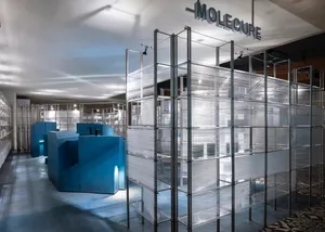 Modern exhibition space featuring metallic structures and plastic wrap