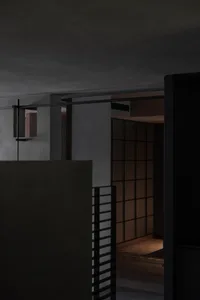 A modern interior space featuring concrete walls and minimalist design elements.