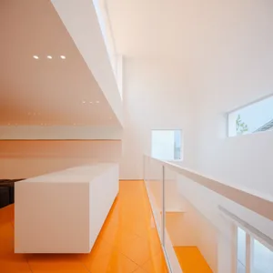 Modern room with white walls and orange flooring, minimalist design aesthetic