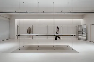 Modern minimalist commercial display featuring metallic elements on a white background.