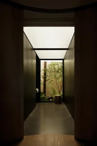 A minimalist interior design space featuring wooden elements and natural light.