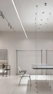 A minimalist interior space featuring white materials and modern furniture.