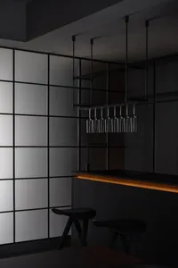 A sleek, minimalist black bar counter with metallic accents.
