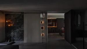 Modern kitchen interior with dark wood cabinetry and marble countertops.