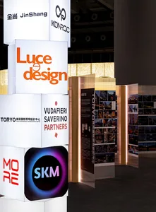 Modern interior design exhibition wall showcasing various design companies.