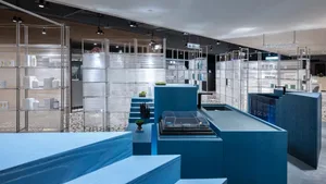 Modern interior design featuring wooden flooring and glass elements.