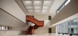 A modern interior space featuring a striking red wood staircase with a sleek, contemporary design.