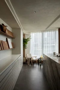 A modern kitchen featuring minimalist design with concrete and marble elements.
