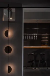 A modern kitchen with metallic finishes and minimalistic design.