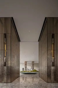 Modern lobby with metallic textured walls and marble flooring