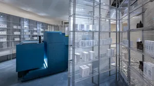 Modern retail storefront with glass display cases and metal shelving.