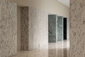 A minimalist interior space with marble walls and floors.
