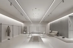 Modern minimalist retail store featuring metal, glass, and white materials