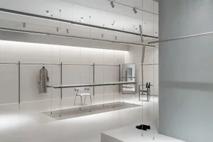 Modern minimalist retail store interior with transparent glass fixtures and minimalist design elements.