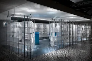 Modern modular exhibition space with plastic-wrapped metal grids.