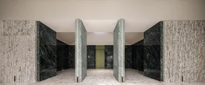 An elegant modern lobby featuring marble walls and flooring.