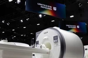 MRI scanner displayed at an exhibition with a focus on medical imaging technology.