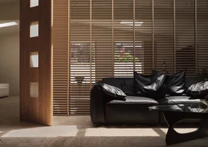 Modern black leather sofa in a contemporary living room setting with minimalistic decor.