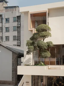 Modern building exterior featuring glass walls and concrete elements.
