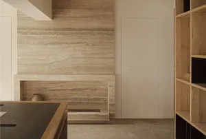 A modern kitchen featuring marble walls and a sleek, minimalist design.