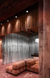 Modern, contemporary storefront with fabric panels, metal accents, and large glass windows.