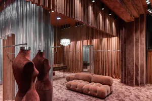 Modern retail storefront with velvet textured curtains, minimalistic design, and soft lighting.