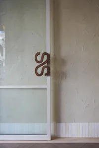 A modern interior door handle made of wood.