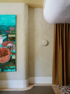Modern residential interior with abstract artwork displayed on textured wall background.