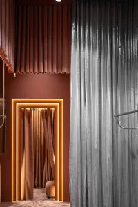 Modern interior with orange and gray curtains made of velvet material.