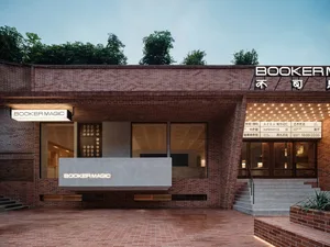 Exterior facade of Booker Magic retail store featuring a brick wall and a sign with the name 'BOOKER MAGIC'.