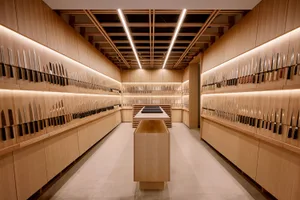 A meticulously organized knife shop featuring a variety of knives mounted on wooden walls.