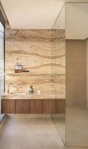 Contemporary bathroom featuring marble countertops and cabinets, minimalist design.