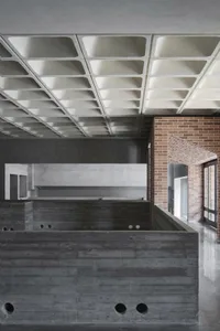 Industrial-style office space featuring concrete and brick walls, with a visual focus on the unique interior design elements