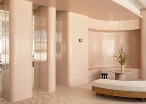 A modern living room with smooth pastel-colored walls and a comfortable seating area.