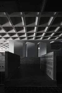 A contemporary office space featuring concrete and glass materials.