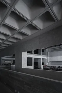 A minimalist restaurant interior with a concrete ceiling and metal walls.