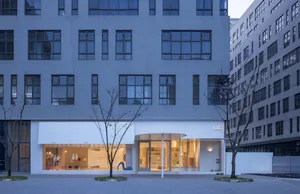 Modern storefront with glass walls and concrete materials.