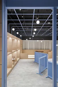 A modern retail storefront featuring a minimalist design with wood tiles on the walls and floor.
