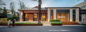 Modern retail storefront with wood, glass, and metal materials.