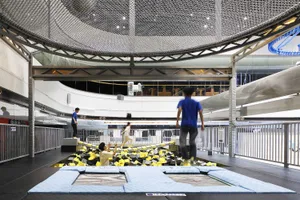 People playing in an indoor playground with foam cubes
