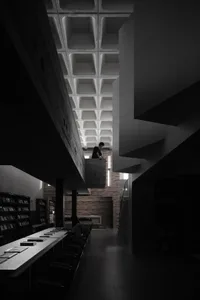 A modern library with a concrete base and open ceiling space.