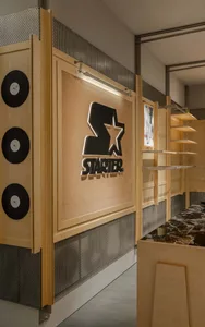 Shop with minimalist interior design featuring wooden shelves and a leather workspace