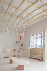 A minimalist retail space featuring concrete flooring and wooden accents.