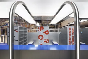 View of a spacious, industrial-style sports center featuring metal shelving units.