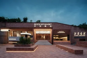 A modern retail storefront with brick and concrete materials. Lighting features prominently. Interior design elements include