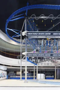 Circular metal structure and staircases of an industrial-themed Xbox Sports Center