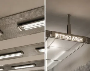 Metal ceiling with a sign that reads 'fitting area' in white lights.