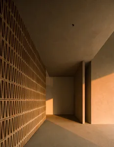 A minimalist interior with brick and concrete walls and floor.