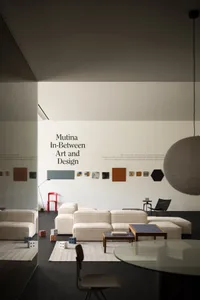 Minimalist living room with fabric seating, modern art, and sleek furniture.